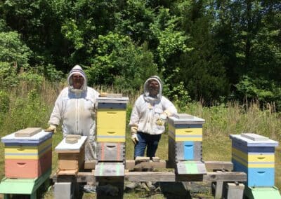 a couple wearing bee keeping suits and veils